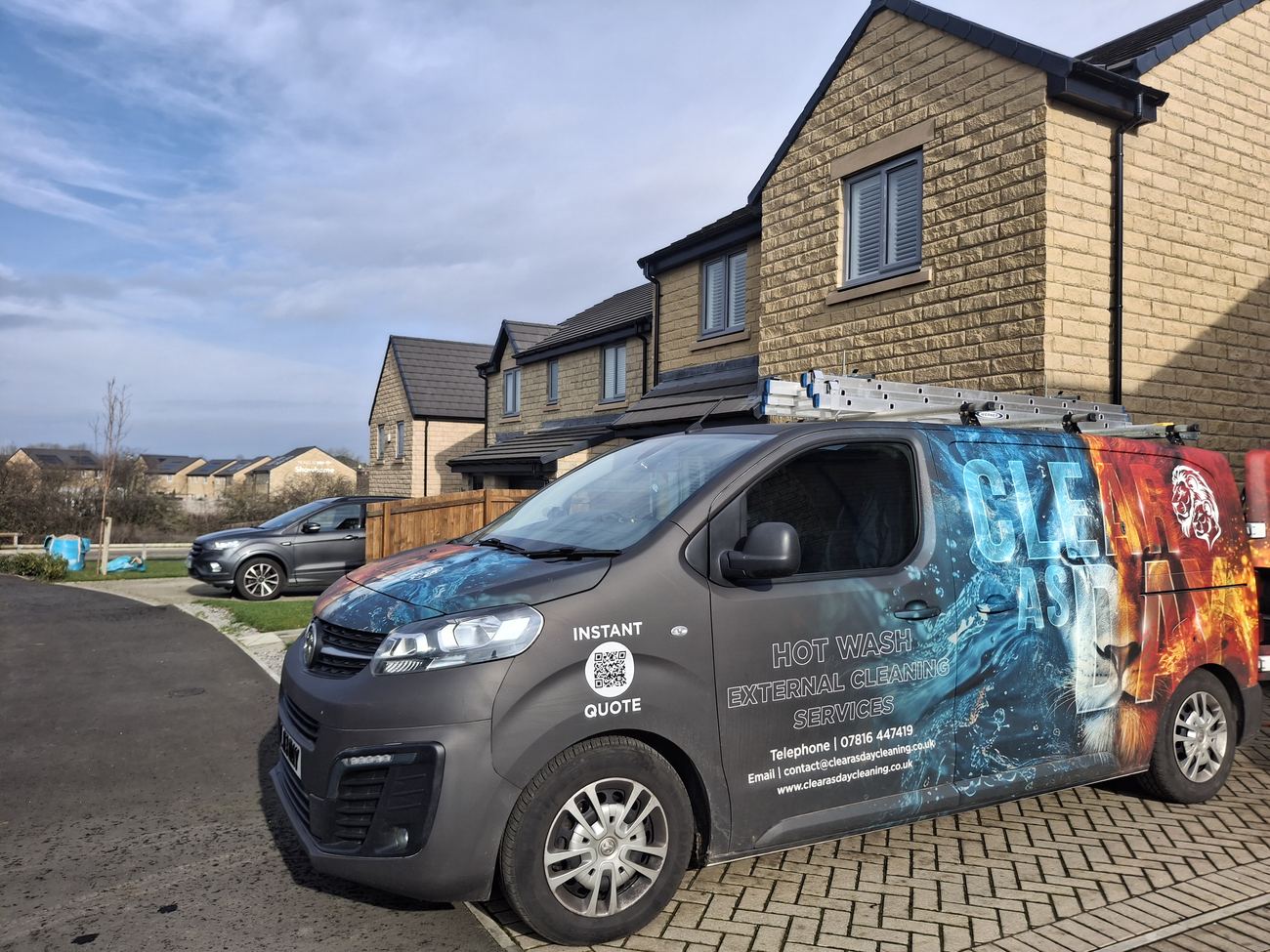 The liveried Clear As Day van parked outside a house on a job.
